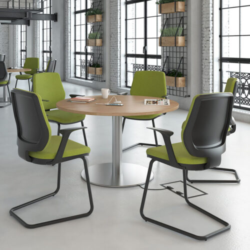 Breakout chairs with a black cantilever frame and green fabric seat