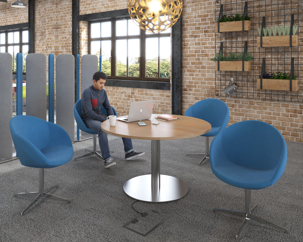 Fabric breakout chairs around a circular meeting table