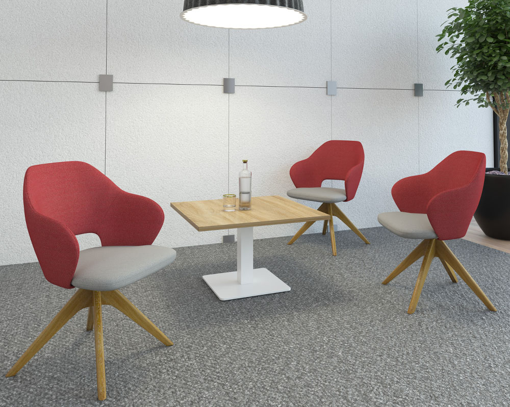 Breakout chairs in red and grey fabric with wooden legs around a square coffee table