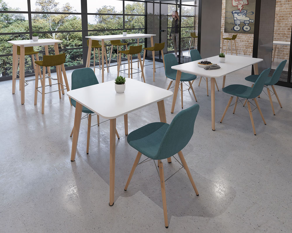 Café and bistro chairs with wooden legs and green fabric seat. Around a square dining table, with white top and wooden legs