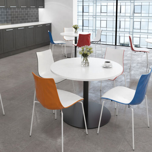 Four canteen chairs in white around a circular dining table