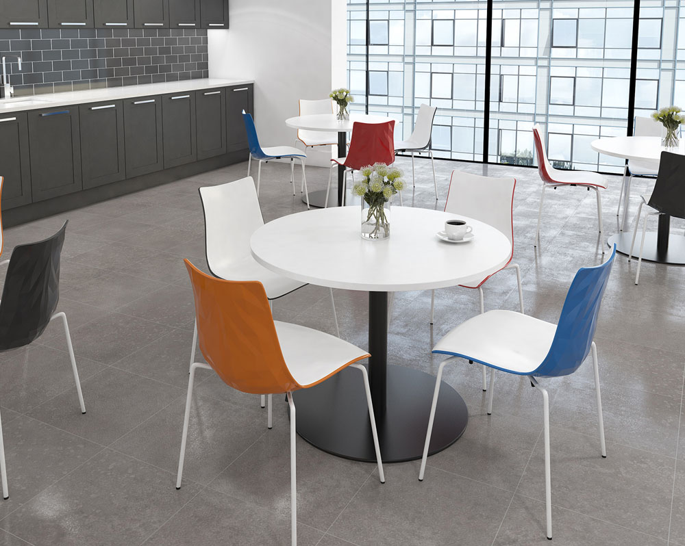 Four canteen chairs in white around a circular dining table