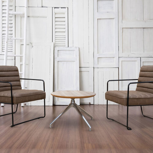 2 Industrial reception chairs in brown faux leather and a small round coffee table