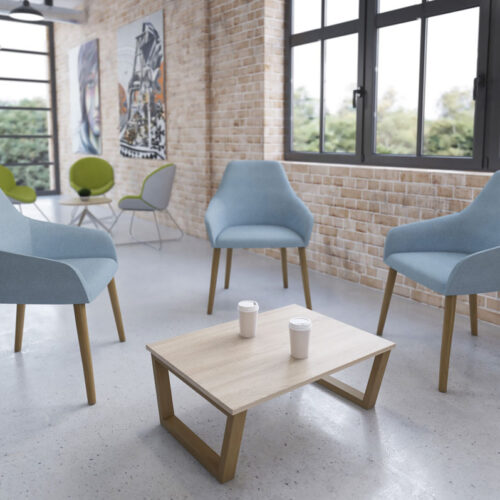 3 Lounge chairs in pale blue fabric and with wooden legs, and a small rectangualr coffee table