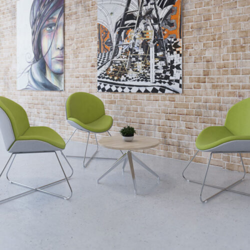 Three lounge chairs in green and grey fabric, and with a criss-cross chrome sled frame, around a small circular coffee table