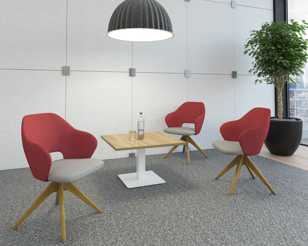 Three lounge chairs in red and grey fabric and a pyramid wooden base around a small square coffee table with oak top