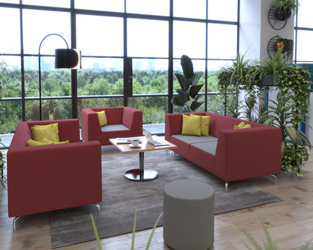 Low back sofa and breakout chairs in red and grey fabric around a square coffee table