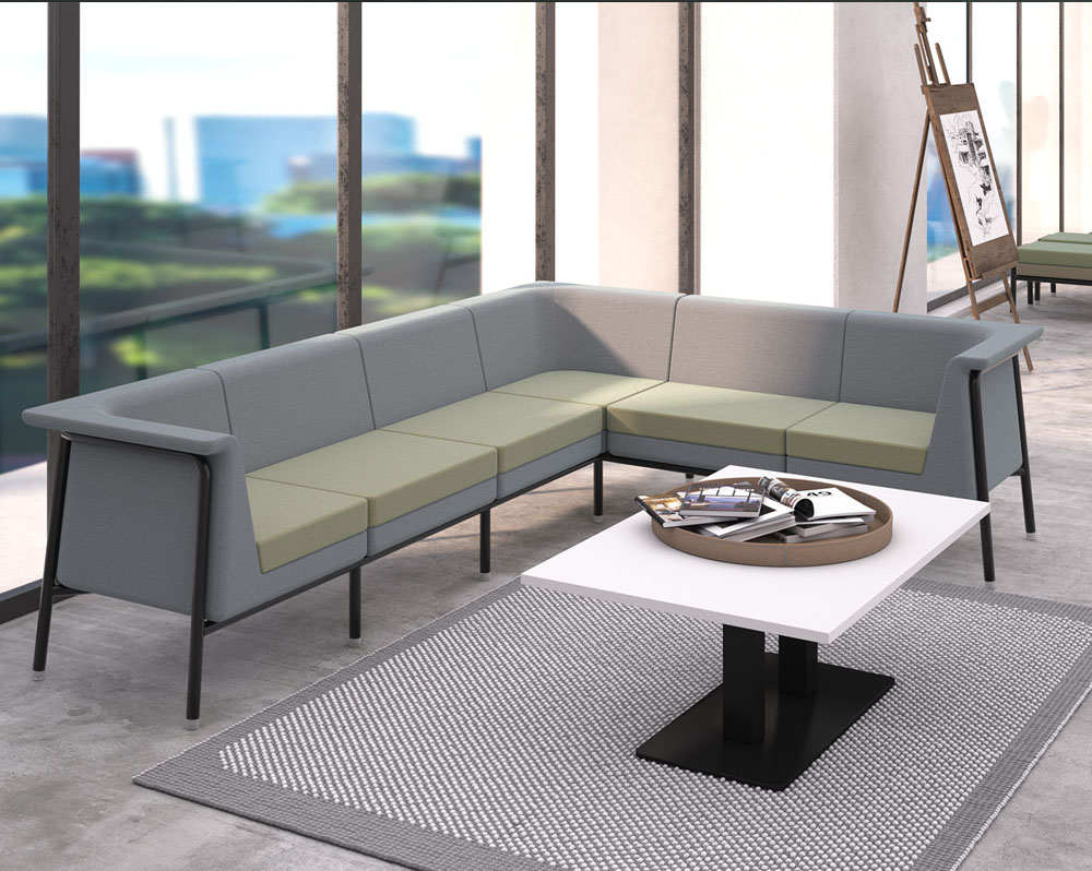Metal framed modular reception chairs in grey and green fabric, and a square white coffee table