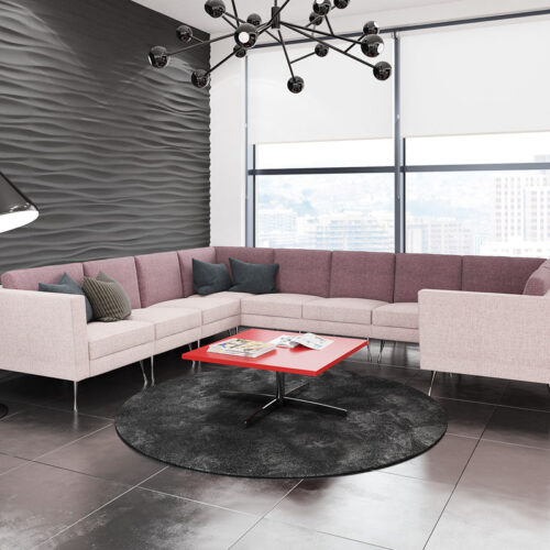 Modular reception chairs in pale pink fabric and grey cushions, plus a square coffee table with red top