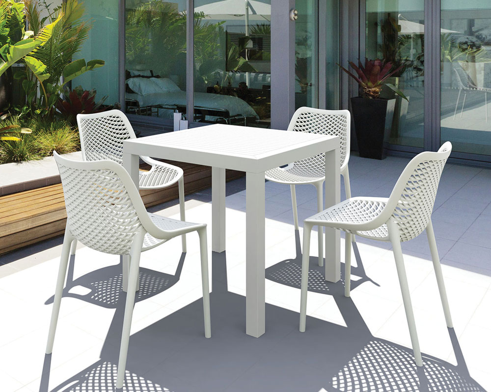 Four white outdoor breakout chairs around a square table
