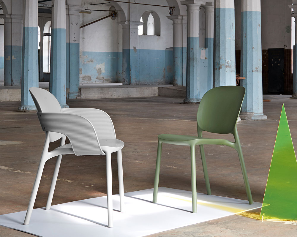 Plastic waiting room chairs in green and in grey.