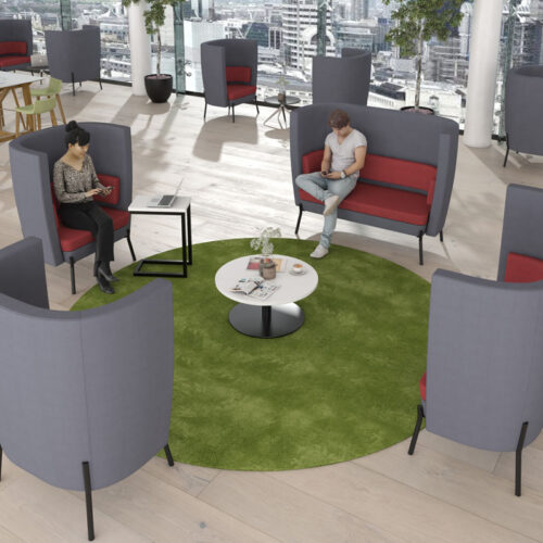 Social spaces high back sofa and armchairs in grey and maroon fabric, around a small white circular coffee table