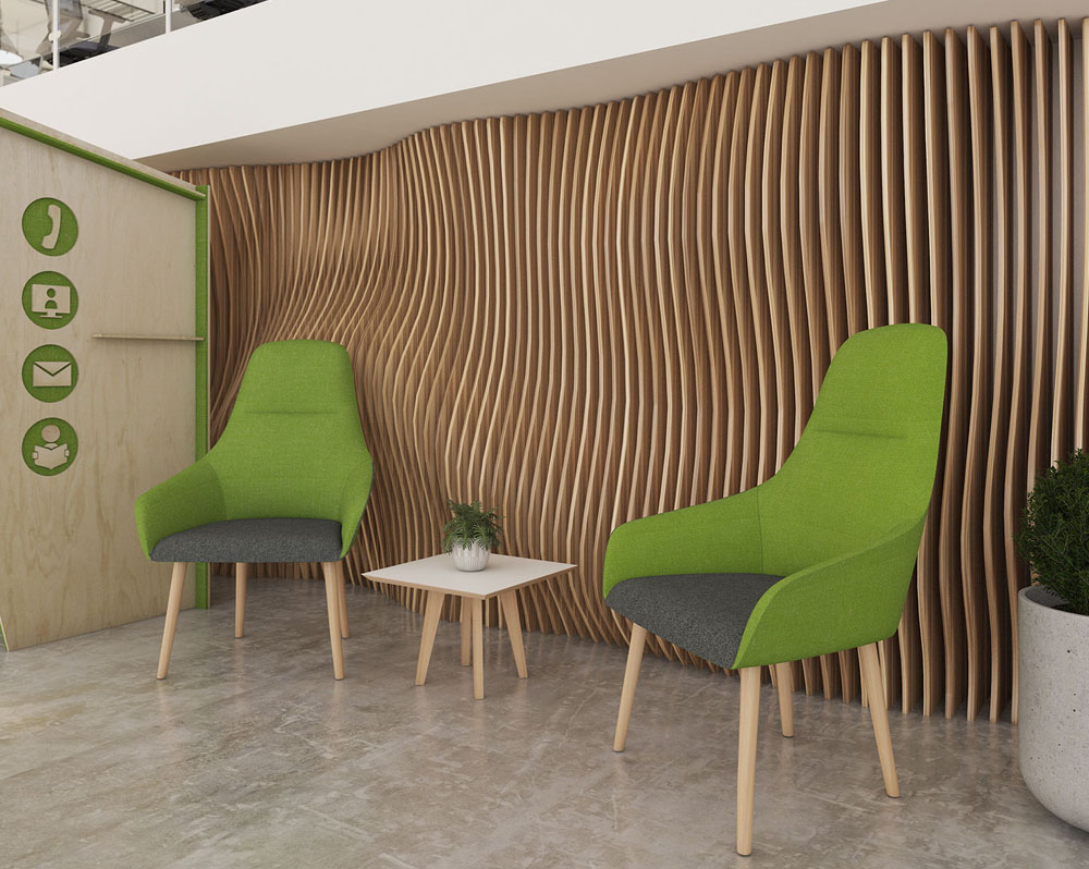 Two green and grey fabric lounge chairs and a small square coffee table in a social space