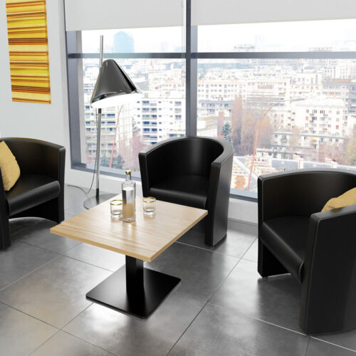 Three black leather tub chairs around a square coffee table