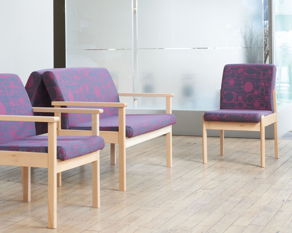 Fabric chairs with a wood frame in a waiting room.