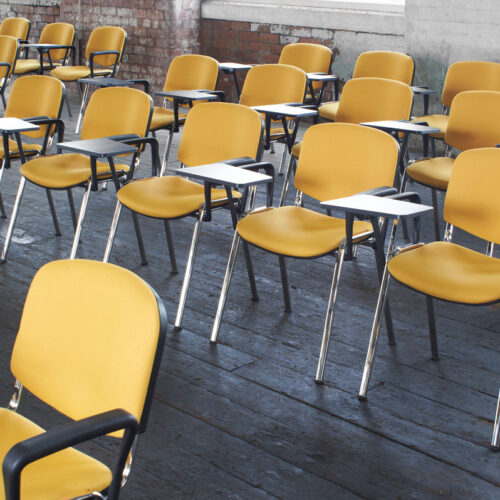 Stacking conference chairs with a writing tablet