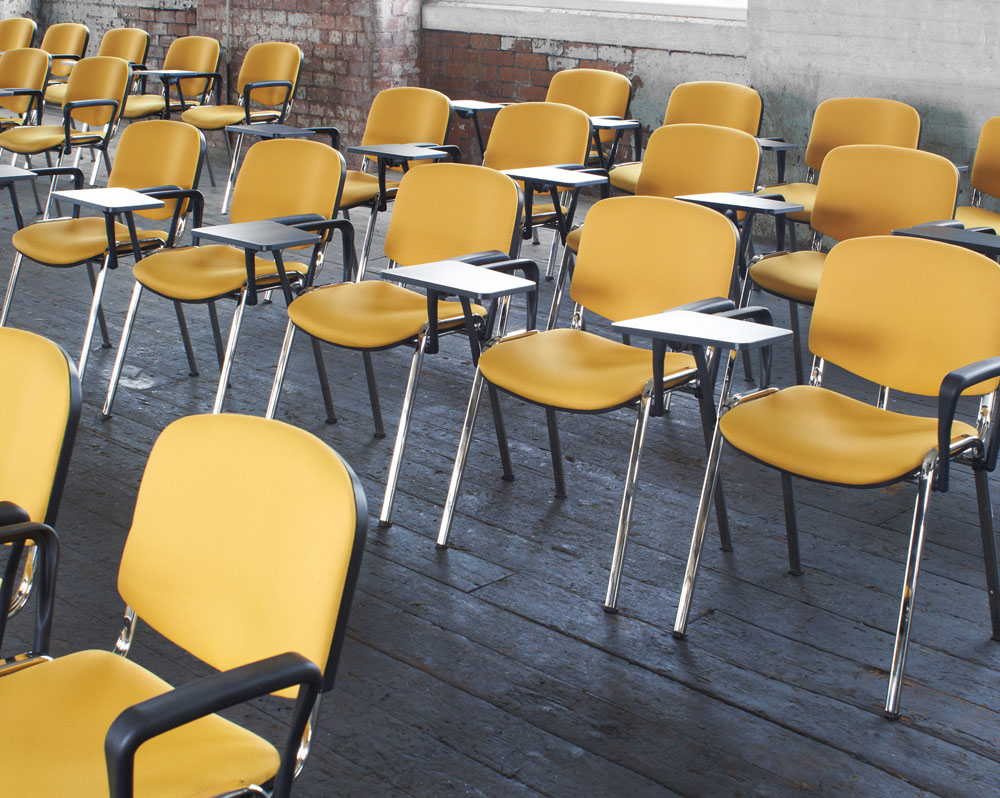 Stacking conference chairs with a writing tablet