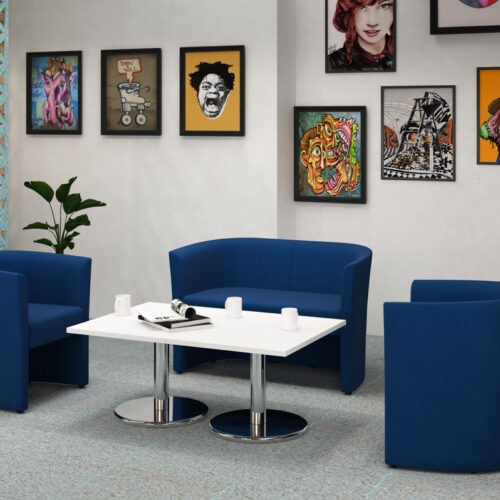 Tub reception chairs in blue fabric, and a white coffee table with chrome legs