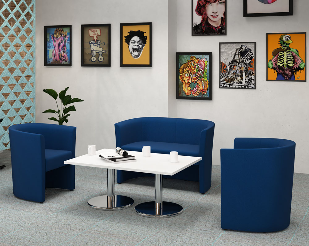 Tub reception chairs in blue fabric, and a white coffee table with chrome legs
