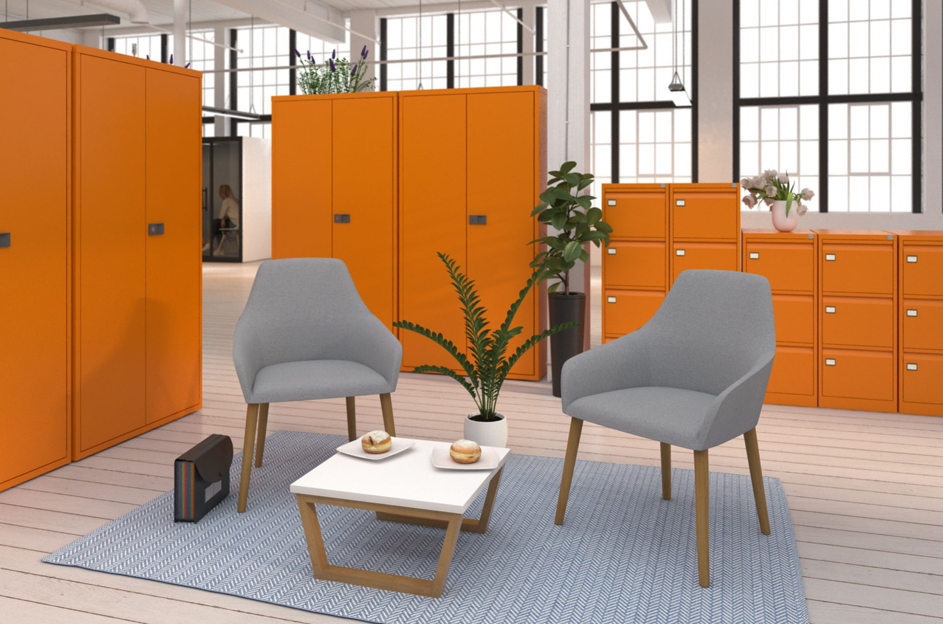 Waiting room chairs in grey fabric and wooden legs, and a small white coffee table, in a waiting area