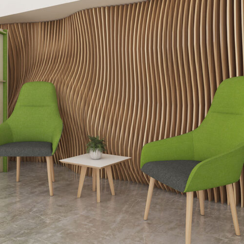 Waiting room lounge chairs in green and grey fabric, with wooden legs. In a modern reception area.