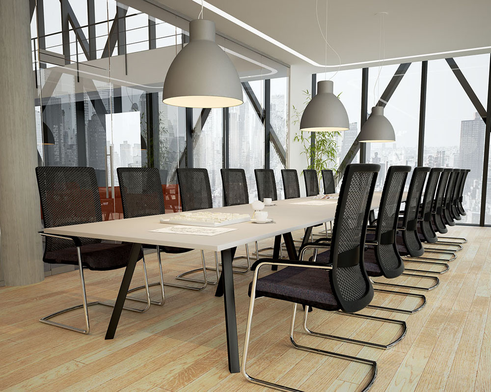 A large boardroom table with black cantilever chairs around it.