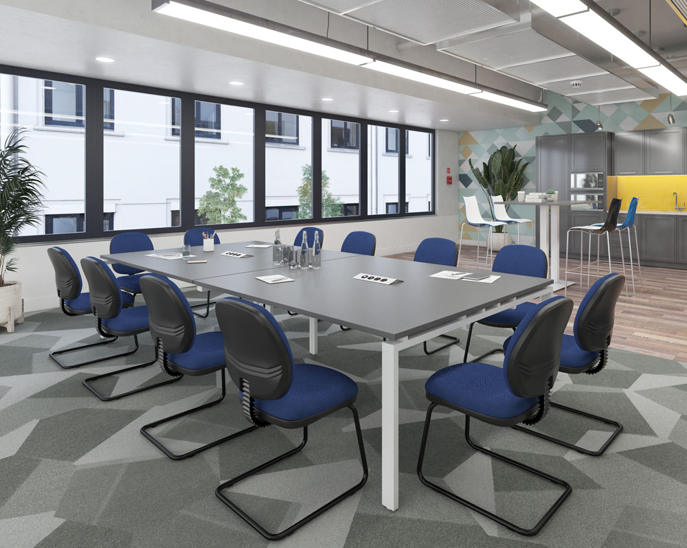 A large bench meeting table surrounded by blue cantilever meeting chairs