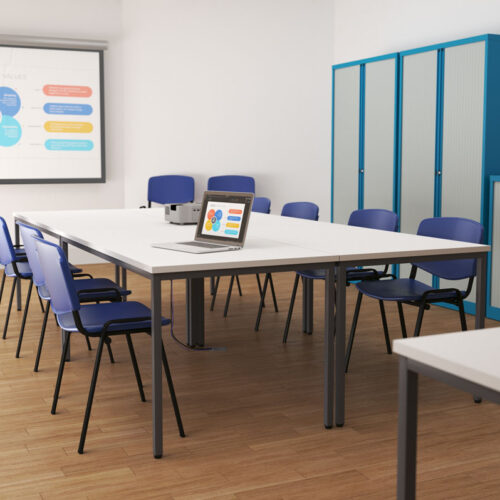 4 rectangular education tables, with blue chairs, in a school classroom