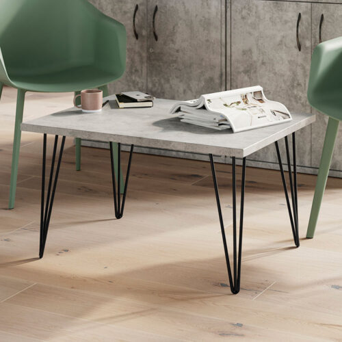 A rectangular coffee table with hairpin legs and two lounge chairs