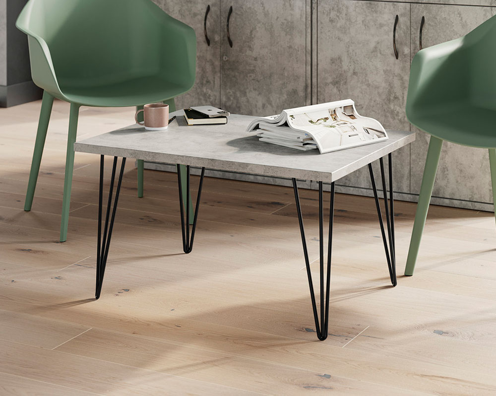 A rectangular coffee table with hairpin legs and two lounge chairs
