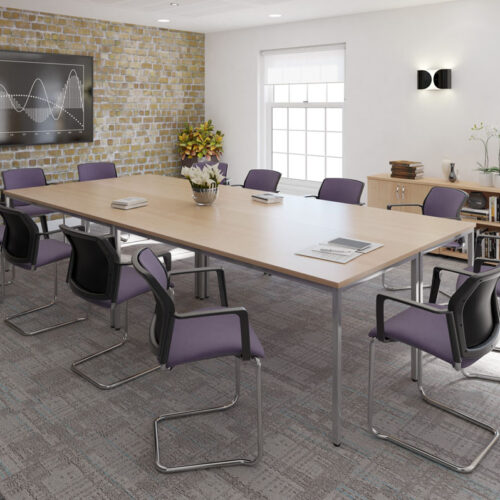 A large rectabgular meeting table surrounded by cantilever meeting chairs