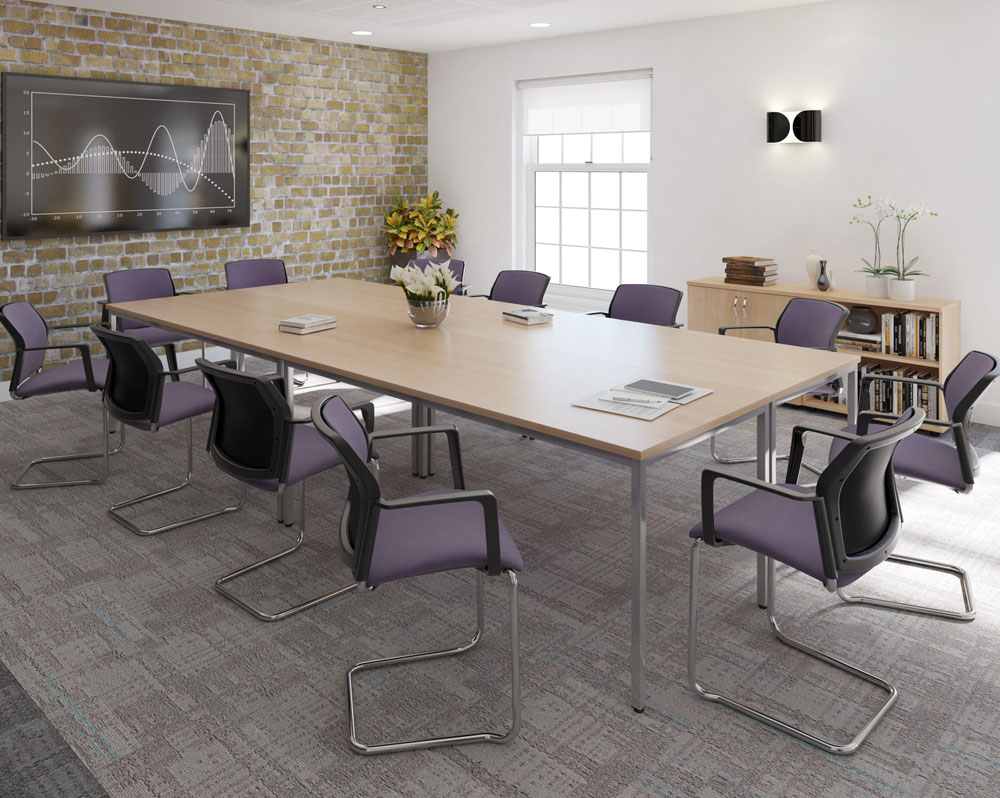 A large rectabgular meeting table surrounded by cantilever meeting chairs