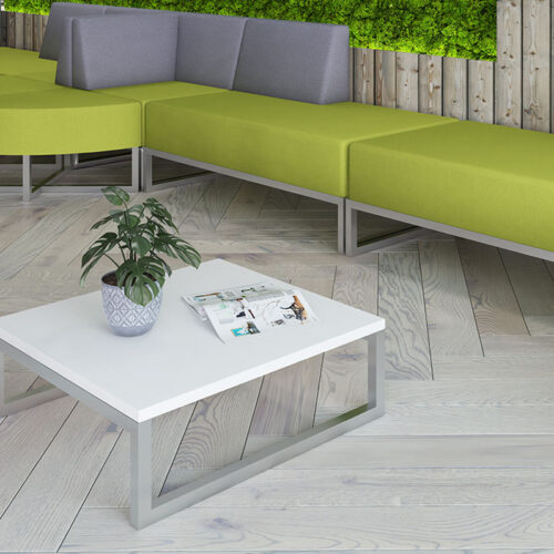 Nera coffee table with white top and silver frame, and modular seating in green and grey fabric