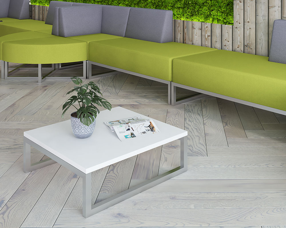 Nera coffee table with white top and silver frame, and modular seating in green and grey fabric