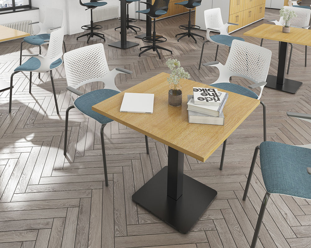 A square table in a modern canteen, surrounded by 3 canteen chairs