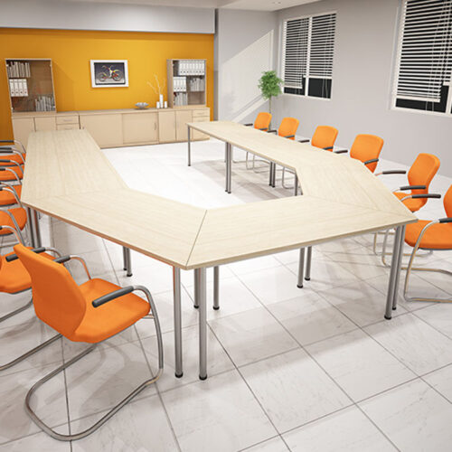Trapezoidal tables, surrounded by cantilever meeting chairs in a modern training room