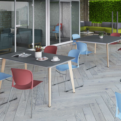 Wooden leg meeting tables and chairs in a large open plan office
