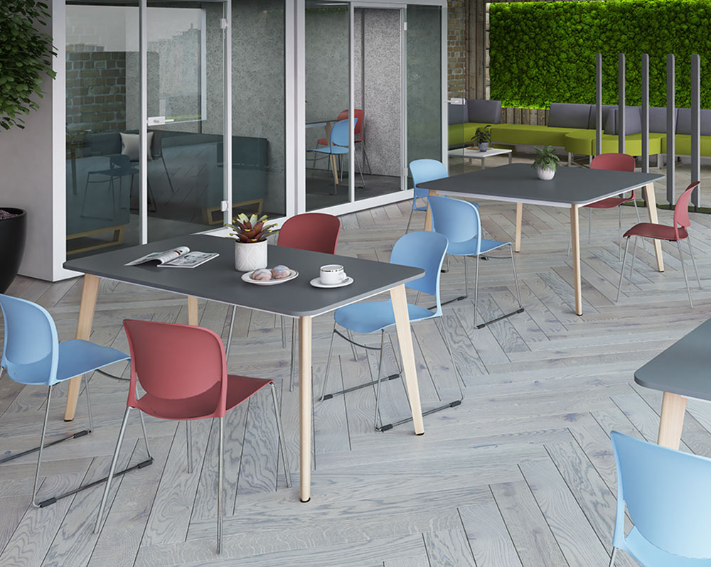 Wooden leg meeting tables and chairs in a large open plan office